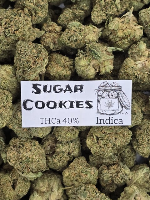 Closeup of cannabis buds labeled Sugar Cookies strain, THCa 40% Indica variety